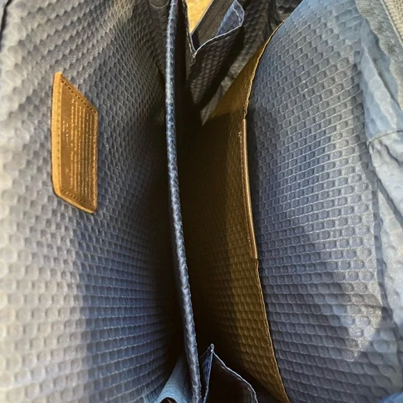 Tumi blue and black backpack. All zips & interior excellent. Two small spots.